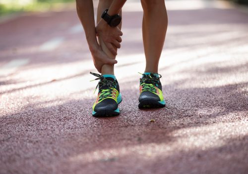 Female runner suffering with pain on sports running injury